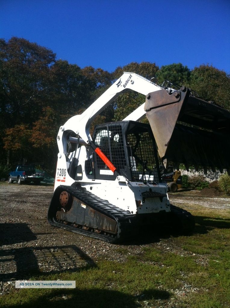 2003 Bobcat T300 And 2006 Trailer Skid Steer Loaders photo