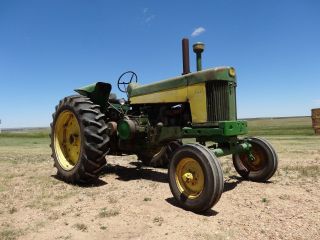 John Deere 730.  Wide Front End.  3 Point Hitch. photo
