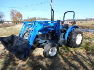 Holland Tn55 Diesel Farm Tractor With Self Leveling Holland 32la Loader photo